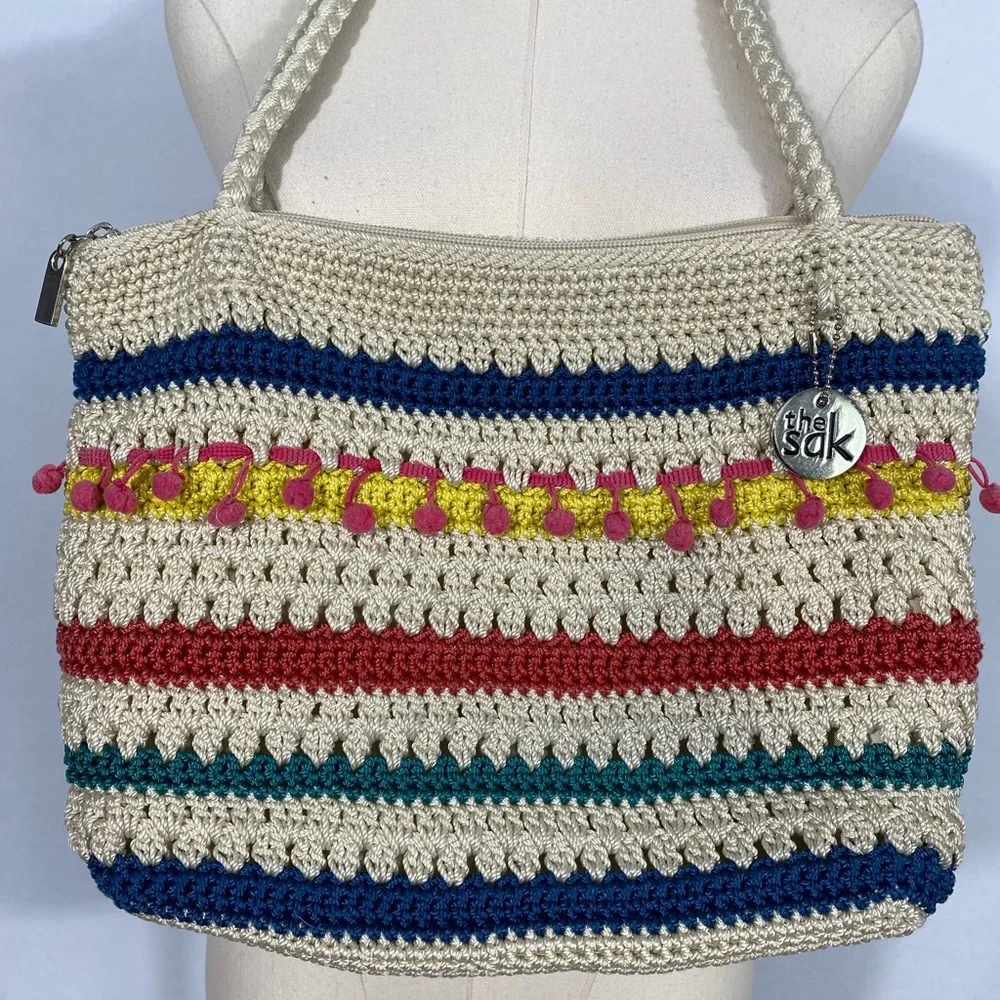 The Sak crocheted striped shoulder bag with pink pom-poms Casual Classics